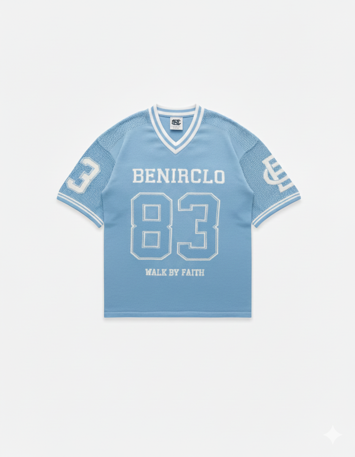 Benir Clothing light blue knit jersey with white 83 graphic, V-neck collar, and Walk By Faith text on front.